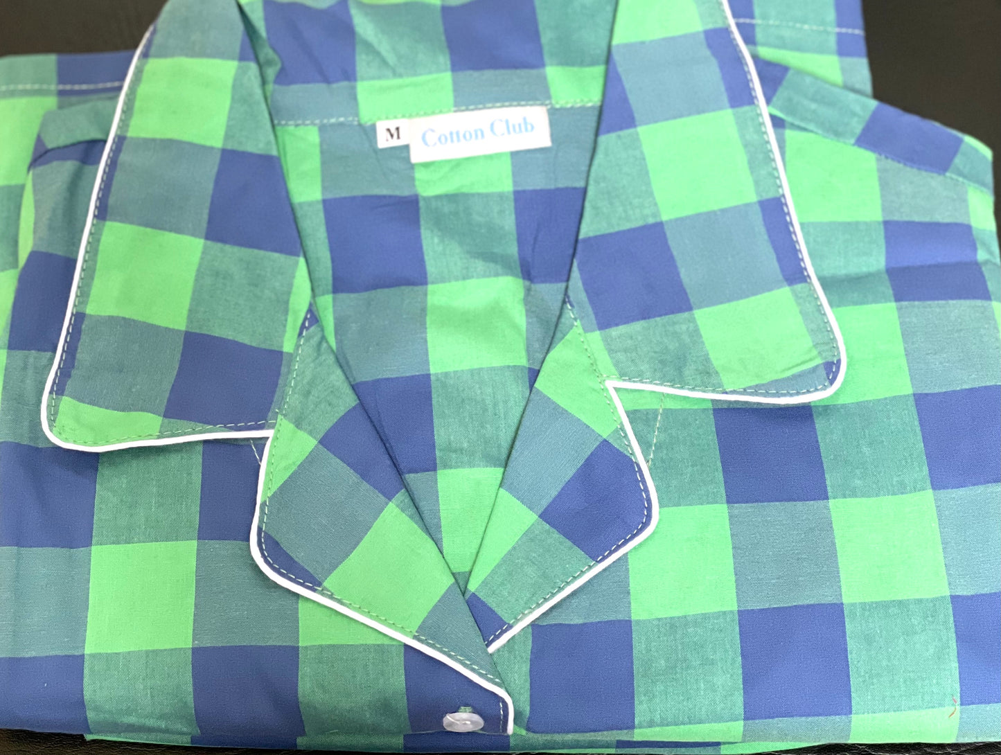 Front view folded green and blue check pattern of a pj set in shorts for men and women, M size