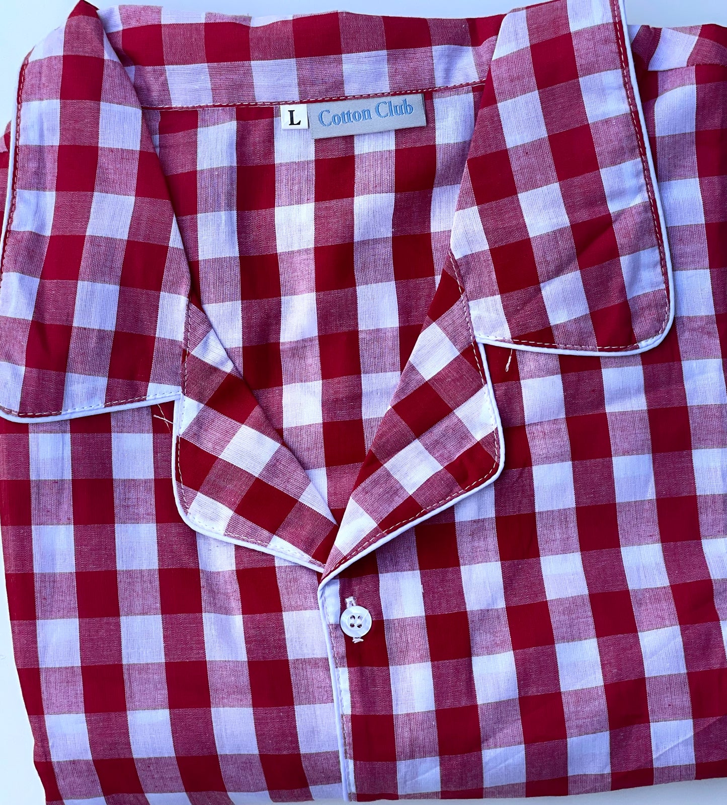 Top view of red white check cotton pajamas for men and women, large size
