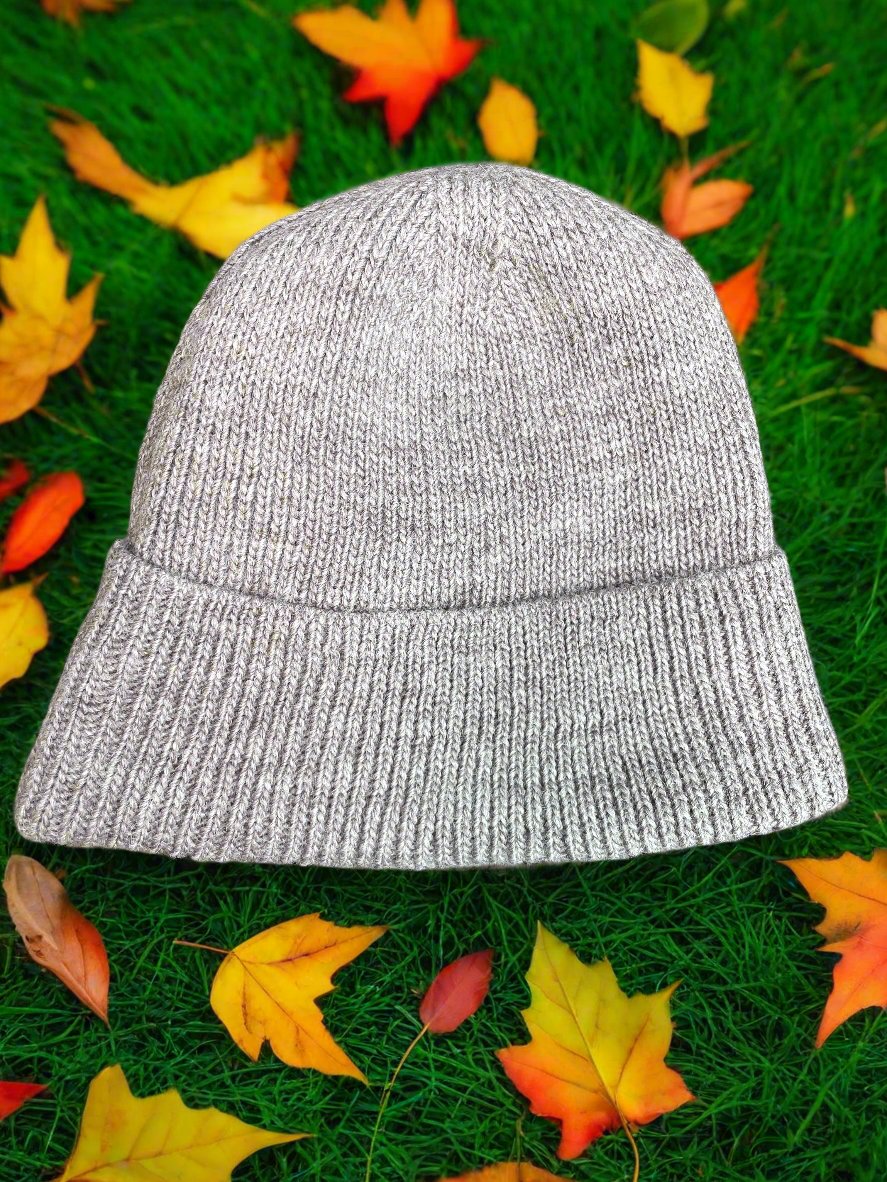 Hand-made knitted wool beanie with recycled fleece lining for comfort and warmth while reducing waste and protecting environment