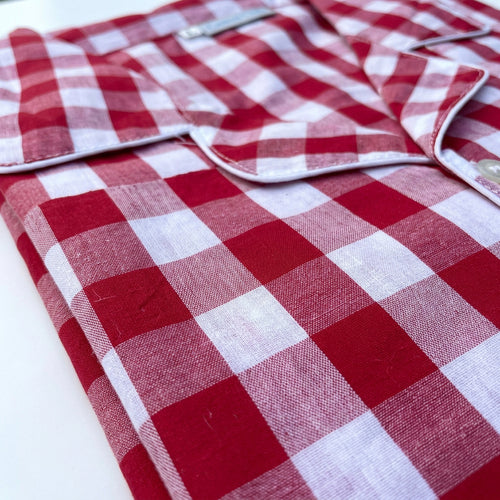 Close-up fabric showing the folded cotton pajamas in classic red and white pattern