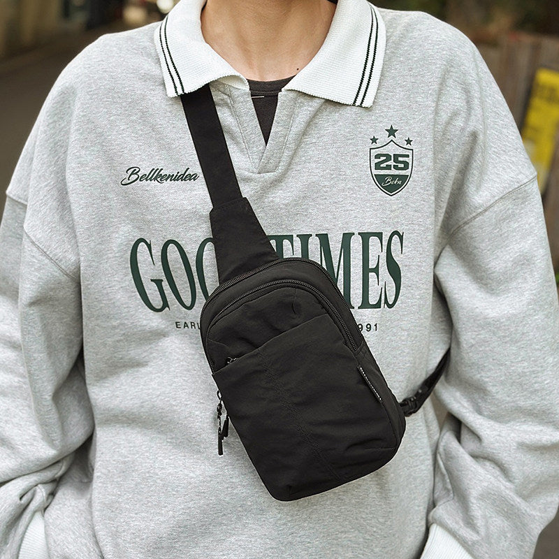 A person is wearing a black Japanese-Inspired Mini Crossbody Bag