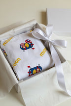 A folded white Pajama Set with Minions Characters in a gift box.