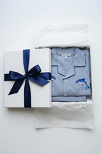 Folded Pajama Set long sleeves with blue little dolphins in a gift box.