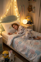 A child sleeping soundly in a cozy bedroom, wearing a matching pajama set with Minions character. The room is decorated with fairy lights, a dreamcatcher, shelves with plush toys, Minions.