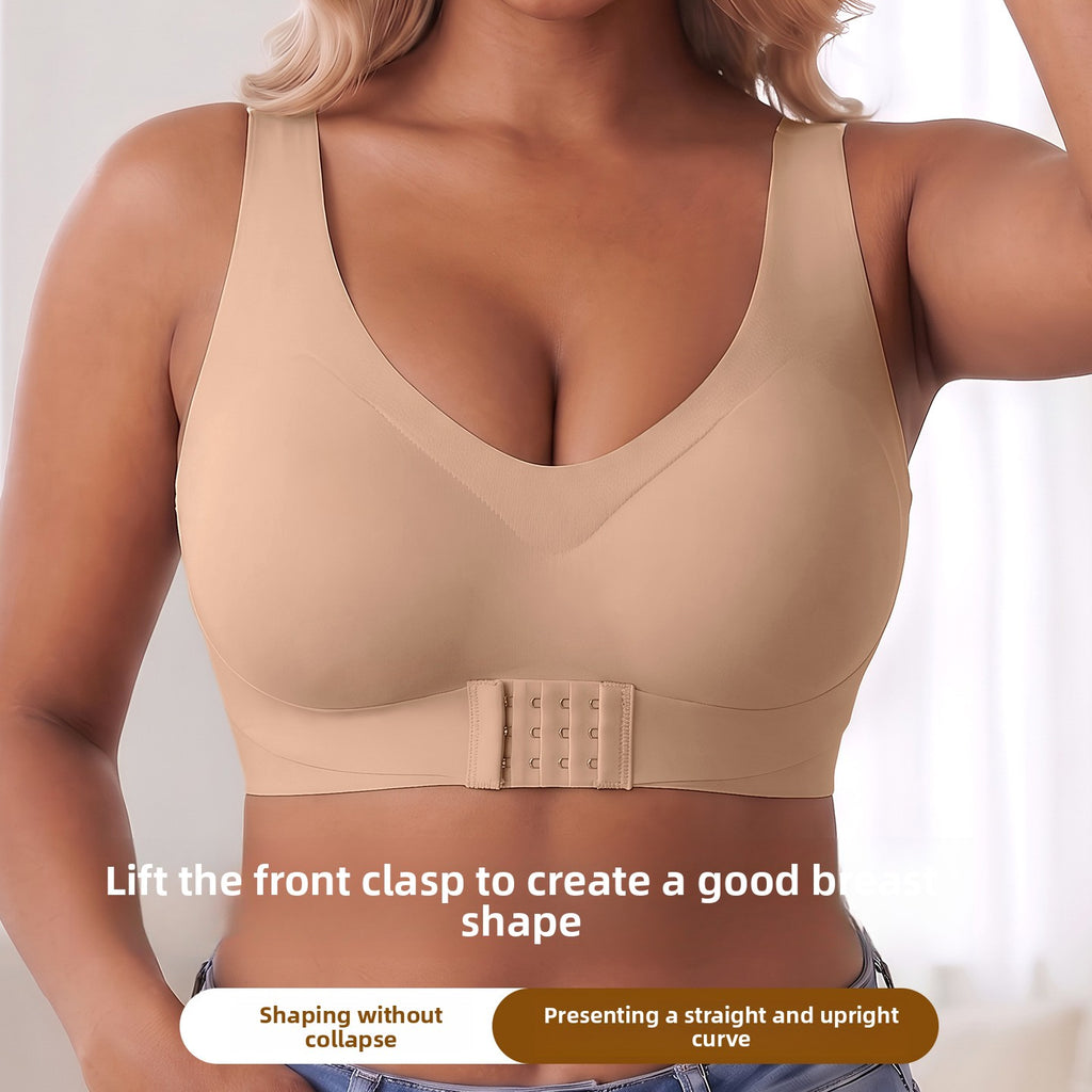 A woman wearing a beige wireless bra with a built-in shaper band and front clasp