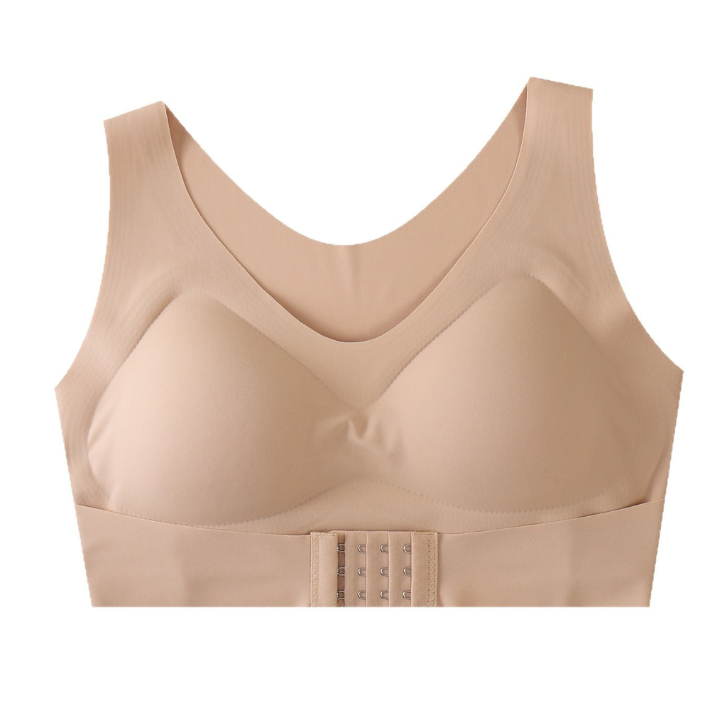A beige wireless bra with a wide underband and a central hook-and-eye closure, shown against a plain white background.