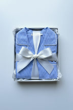 Folded cotton Pajamas in blue and white with cars in a gift box.