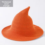 Knitted witch hats for Halloween in orange colour