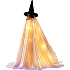 A witch ghost Halloween decoration with warm yellow LED fairy lights glowing inside