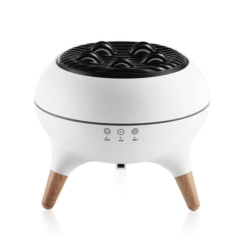 White and black humidifier with wooden legs on a white background