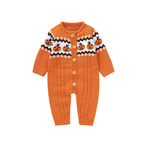 An orange knit baby cardigan romper with a Fair Isle style pattern featuring jack-o'-lanterns on the chest, gold buttons, and cable-knit leg panels, shown on a plain white background.