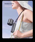 A woman in a white hat and white dress models a black cylindrical hanging neck fan with a black strap, shown against a pale blue sky background with promotional text.