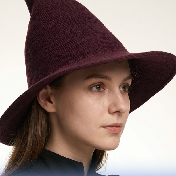 Woman wearing purple knitted witch hat for Halloween